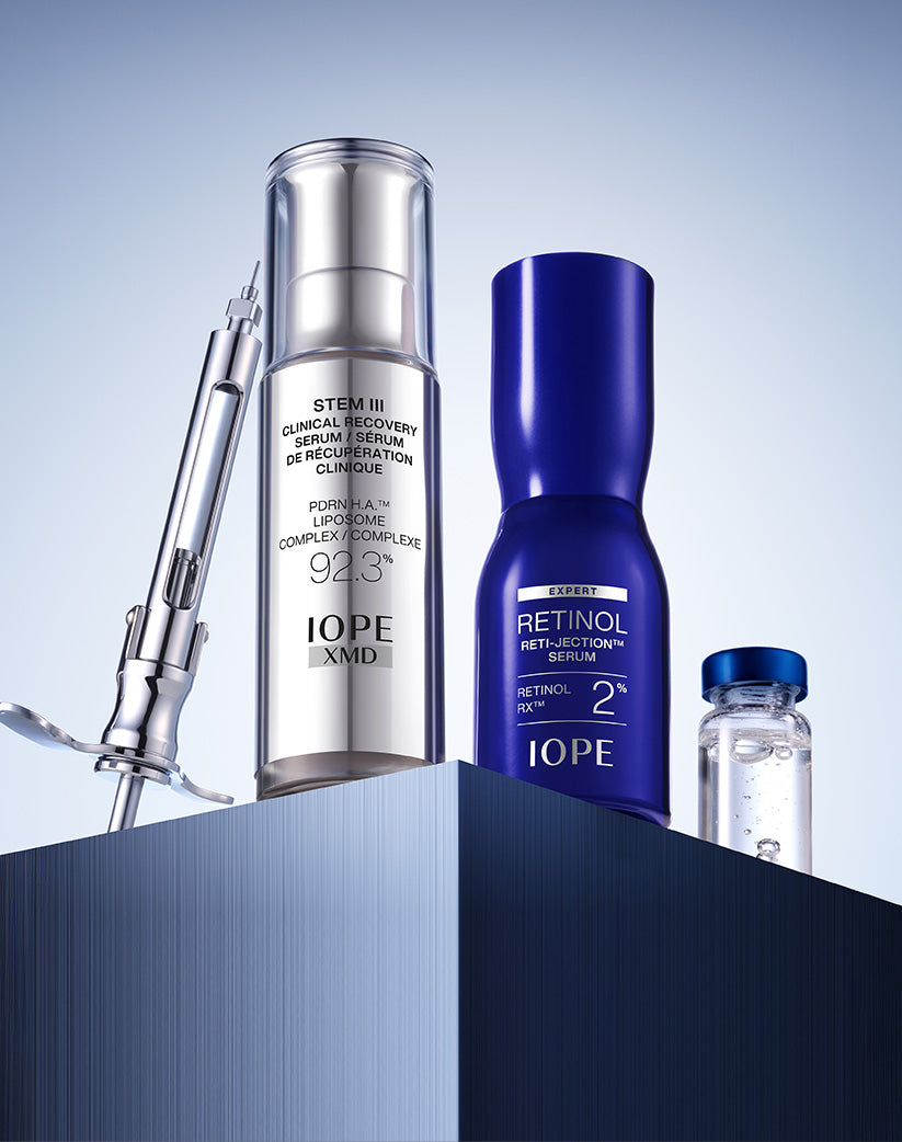 IOPE skincare products including a serum, cream, and bottle on a gradient blue background